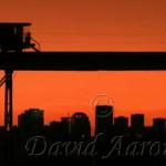 This caboose sihloutted against  Edmonton's skyline shows a  beautiful sunset.