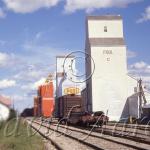 A row of grain elevators.  Image blurred for the internet.
